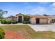 A well maintained home with a two-car garage and mature landscaping at 9208 Butler Blvd, Weeki Wachee, FL 34613