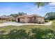 Side of Home with garage showcasing mature landscaping and exterior details at 9208 Butler Blvd, Weeki Wachee, FL 34613
