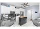 Bright kitchen showcasing white cabinets, granite countertops, stainless steel appliances, and a functional kitchen island at 9208 Butler Blvd, Weeki Wachee, FL 34613