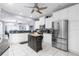 A bright kitchen with white cabinets, stainless steel appliances, granite countertops, and a large island at 9208 Butler Blvd, Weeki Wachee, FL 34613