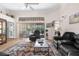 Cozy living room featuring comfortable seating, natural light, and sliding glass doors at 9208 Butler Blvd, Weeki Wachee, FL 34613