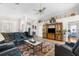 Spacious living room featuring a ceiling fan, a large tv cabinet, a comfortable sectional, and a stylish rug at 9208 Butler Blvd, Weeki Wachee, FL 34613