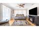 Cozy living room with a plush sofa, entertainment center, and decorative rug, ideal for relaxing and watching TV at 9208 Butler Blvd, Weeki Wachee, FL 34613