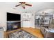 Comfortable living room with a fireplace, TV, and views of the dining area, great for a cozy atmosphere at 9208 Butler Blvd, Weeki Wachee, FL 34613