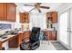 Functional home office with built-in wooden cabinets, a large desk, and a comfortable chair for productivity at 9208 Butler Blvd, Weeki Wachee, FL 34613