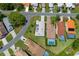 Overhead aerial view of a residential neighborhood featuring tidy homes, well-kept lawns, and mature landscaping at 9400 New Orleans Dr, Weeki Wachee, FL 34613