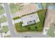 Aerial view of single-story home featuring mature landscaping, screen enclosed patio, and a paved driveway at 9400 New Orleans Dr, Weeki Wachee, FL 34613