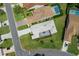 Aerial view of single-story home featuring mature landscaping, screen enclosed patio, and a paved driveway at 9400 New Orleans Dr, Weeki Wachee, FL 34613