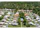 High aerial shot featuring homes with private pools in a peaceful residential neighborhood, set amid mature trees at 9400 New Orleans Dr, Weeki Wachee, FL 34613