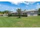 Backyard showcasing a well-maintained lawn and screened lanai, perfect for outdoor enjoyment at 9400 New Orleans Dr, Weeki Wachee, FL 34613
