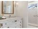 Elegant bathroom featuring a vanity with a marble countertop and a walk-in shower at 9400 New Orleans Dr, Weeki Wachee, FL 34613