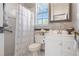 Bathroom featuring decorative shower curtain and large mirror with a vanity and stylish wall design elements at 9400 New Orleans Dr, Weeki Wachee, FL 34613