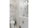 Elegant bathroom with white vanity, decorative mirror, and charming wall details for a serene and stylish space at 9400 New Orleans Dr, Weeki Wachee, FL 34613