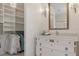 Stylish bathroom with a vanity area, a mirror, and a walk-in closet at 9400 New Orleans Dr, Weeki Wachee, FL 34613