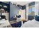 Charming bedroom featuring a plush blue rug, a comfortable white chair, and a bright window for natural light at 9400 New Orleans Dr, Weeki Wachee, FL 34613