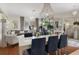 Combined living and dining area with lots of light, chandeliers, and a view of the fireplace at 9400 New Orleans Dr, Weeki Wachee, FL 34613