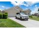 Charming single-story home with well-manicured lawn, a Range Rover, and an attached two-car garage at 9400 New Orleans Dr, Weeki Wachee, FL 34613
