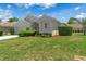 Charming home with a well-manicured lawn, lush shrubs, and inviting front entrance at 9400 New Orleans Dr, Weeki Wachee, FL 34613