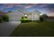 Charming single-story home with a well-manicured lawn and inviting curb appeal set against a colorful sunset sky at 9400 New Orleans Dr, Weeki Wachee, FL 34613