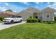 Inviting single-story home features a lush green lawn, landscaped bushes, and a white Range Rover parked in the driveway at 9400 New Orleans Dr, Weeki Wachee, FL 34613