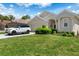 Charming single-story home with a well-manicured lawn, mature landscaping, and a Range Rover in the driveway at 9400 New Orleans Dr, Weeki Wachee, FL 34613