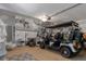 Bright garage featuring a golf cart, epoxy flooring, overhead lighting, and ample shelving space at 9400 New Orleans Dr, Weeki Wachee, FL 34613