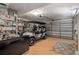 Spacious garage featuring a golf cart, epoxy flooring, and ample shelving space for storage at 9400 New Orleans Dr, Weeki Wachee, FL 34613