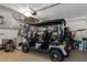 Well-lit garage featuring a golf cart, epoxy flooring, and shelving for optimal storage solutions at 9400 New Orleans Dr, Weeki Wachee, FL 34613