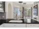 Charming kitchen area boasts black countertops and a pleasant view of the outdoor patio at 9400 New Orleans Dr, Weeki Wachee, FL 34613