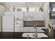 Well-equipped kitchen with white cabinets, stainless steel appliances, and decorative backsplash at 9400 New Orleans Dr, Weeki Wachee, FL 34613