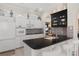 Bright kitchen with white cabinets, tile backsplash, a breakfast bar, and stainless steel appliances at 9400 New Orleans Dr, Weeki Wachee, FL 34613