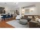 Open living area with dining table and stylish furnishings, with hardwood floors and lots of natural light at 9400 New Orleans Dr, Weeki Wachee, FL 34613