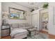 Cozy living room with stylish furnishings, chandelier lighting, and a large mirror reflecting a TV with an exterior view at 9400 New Orleans Dr, Weeki Wachee, FL 34613