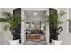 Elegant living room view from entry with hardwood floors, decorative chandeliers, and comfortable seating arrangement at 9400 New Orleans Dr, Weeki Wachee, FL 34613