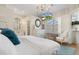 Airy main bedroom featuring an ensuite bathroom and a lovely seating area by the window at 9400 New Orleans Dr, Weeki Wachee, FL 34613