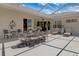 Inviting outdoor patio with a dining area, lounge chairs, and elegant decor, perfect for al fresco dining and relaxation at 9400 New Orleans Dr, Weeki Wachee, FL 34613