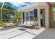 Charming screened lanai featuring comfortable seating, elegant decor, and views of the lush landscaping at 9400 New Orleans Dr, Weeki Wachee, FL 34613