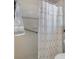 Neutral tiled shower with shower curtain, grab bar, and towel for a safe and functional bathroom design at 9400 New Orleans Dr, Weeki Wachee, FL 34613