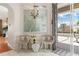 Bright sitting area with stylish chairs, mirrored table, and natural light from the sliding glass doors at 9400 New Orleans Dr, Weeki Wachee, FL 34613