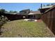 Fenced backyard featuring a patio with an umbrella and a green lawn at 947 Village Dr, Brooksville, FL 34601