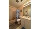 The bathroom shows an updated sink vanity, toilet and shower/tub combo with a shower curtain at 947 Village Dr, Brooksville, FL 34601
