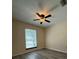 Bright bedroom shows a window overlooking the property and clean gray wood-look flooring at 947 Village Dr, Brooksville, FL 34601
