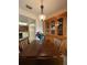 A dining area showcases a wooden hutch and table illuminated by a modern pendant light fixture at 947 Village Dr, Brooksville, FL 34601