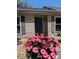 Inviting home exterior with potted plants flanking the front door, adding a touch of charm at 947 Village Dr, Brooksville, FL 34601