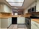 Bright kitchen featuring modern appliances, a skylight, and ample counter space for cooking at 947 Village Dr, Brooksville, FL 34601