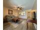 Relax in this cozy living room with a ceiling fan and an archway view into the kitchen at 947 Village Dr, Brooksville, FL 34601