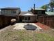 A cozy patio with a table, chairs, and umbrella nestled in a fenced backyard at 947 Village Dr, Brooksville, FL 34601