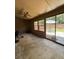 Enclosed sunroom featuring sliding glass doors to the back yard, a ceiling fan, and neutral paint at 947 Village Dr, Brooksville, FL 34601