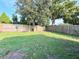 Grassy backyard, surrounded by a wood fence, offering a private outdoor space at 9850 Richwood Ln, Port Richey, FL 34668