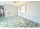 Bright bedroom with tile flooring, neutral walls, and a ceiling fan at 9850 Richwood Ln, Port Richey, FL 34668